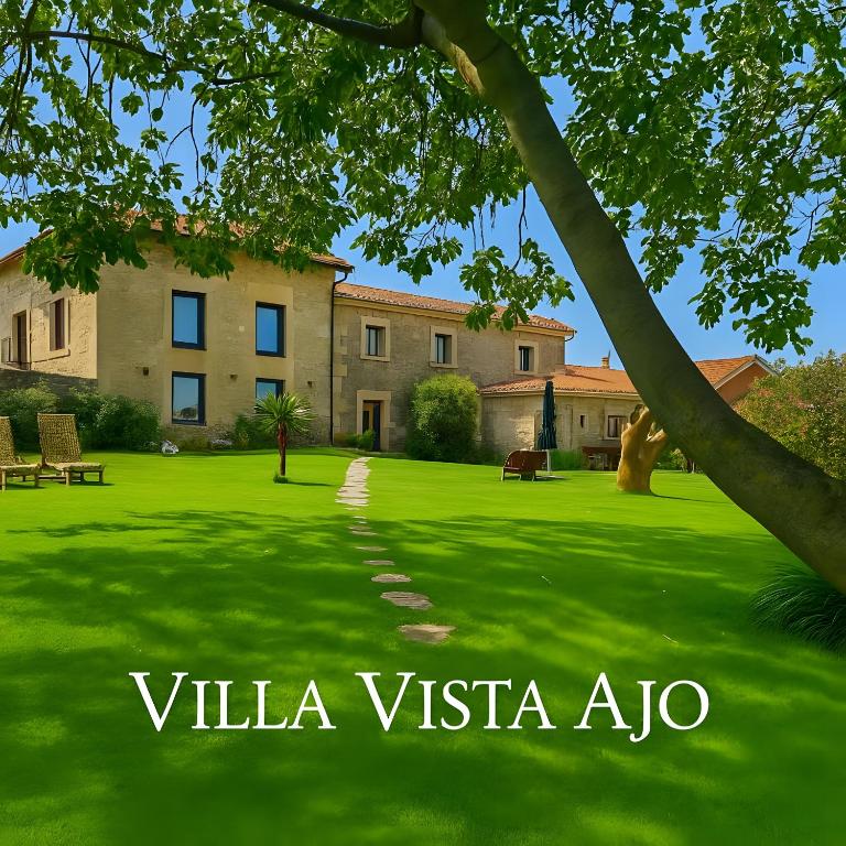a large grassy yard with a building in the background at Villa Vista Ajo in Ajo