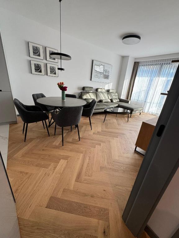 a living room with a table and chairs at Sofia Tech Park Apartments - Premium in Sofia