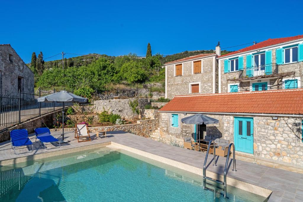 a swimming pool in front of a building at Milia's House Ithaca in Vathi