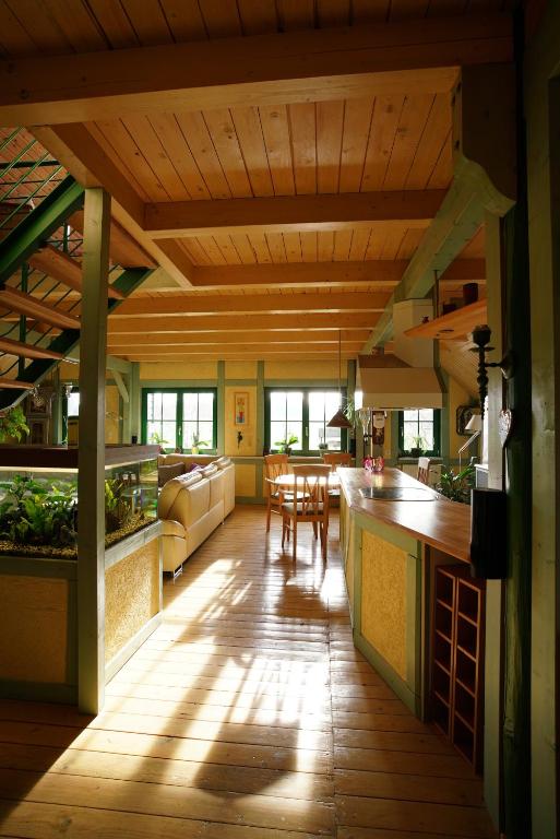 a kitchen and living room with a wooden ceiling at Ferienwohnung Dina in Olbernhau