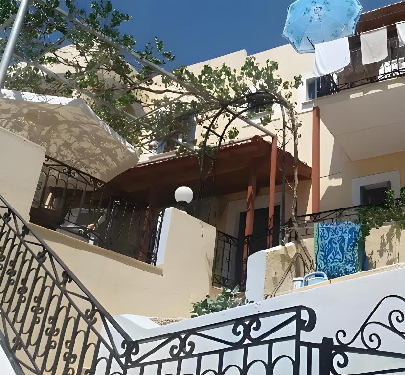 a balcony of a house with a staircase at Yiorgo's Studios in Kalymnos