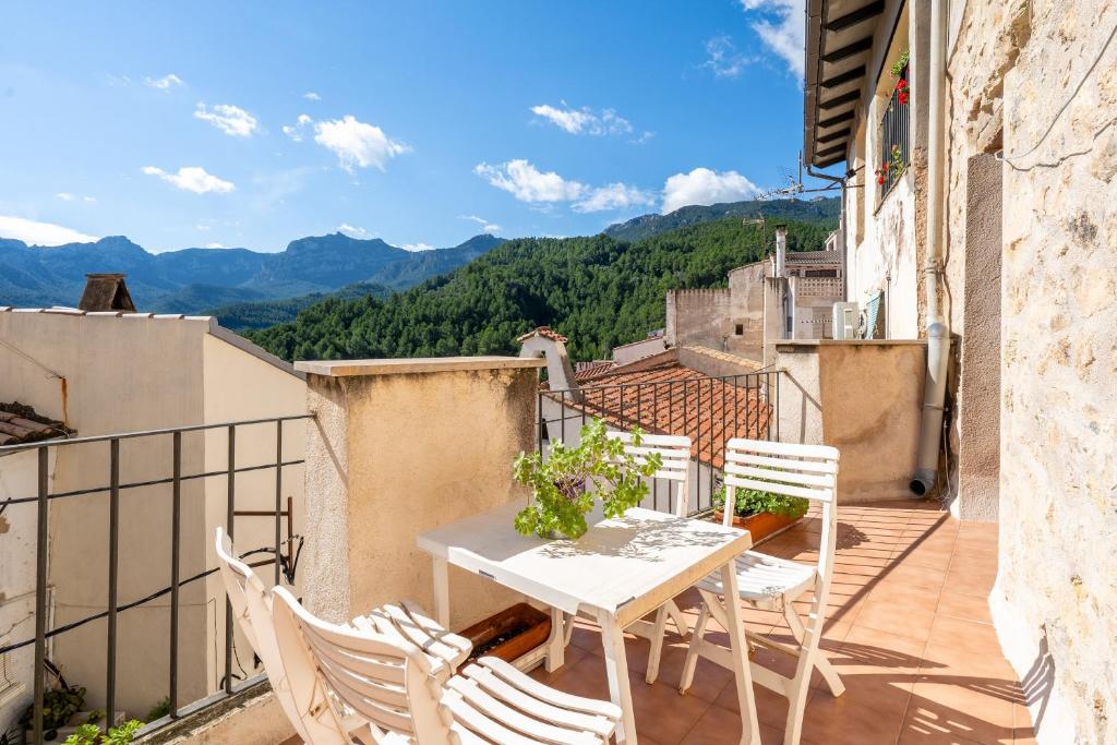 a patio with a table and chairs on a balcony at Ca La Germandat Paüls in Paúls