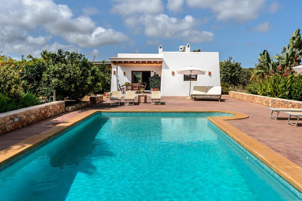 a swimming pool in front of a villa at Can Marsá de Baix in Santa Eularia des Riu