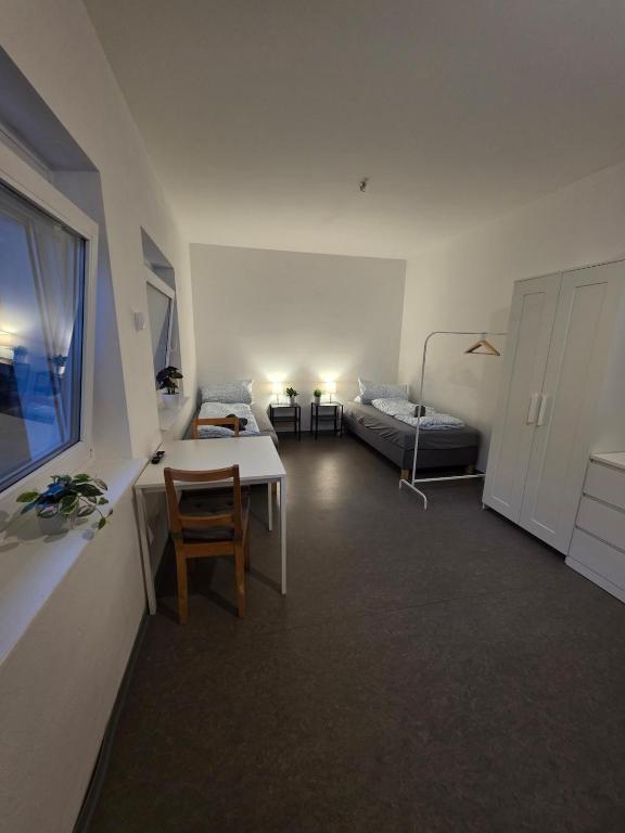 a living room with a table and a bed at Relax after work in Ochsenhausen