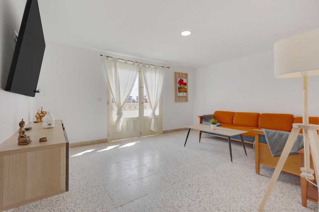 a living room with a couch and a table at Edificio El Baifo Loco - Milena in Gran Tarajal