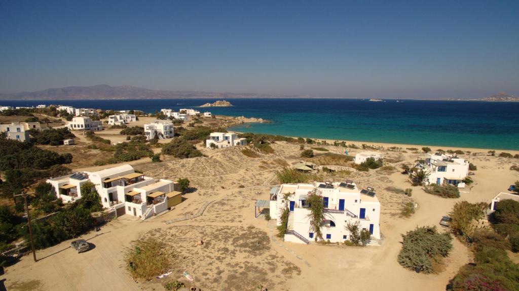 an aerial view of a beach with white houses and the ocean at Victoria Studios & Apartments in Mikri Vigla