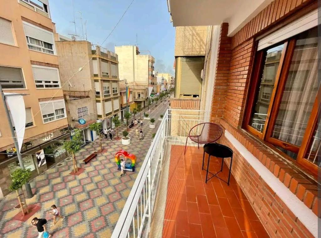 a balcony of a building with people on a street at Hogar dulce hogar. in Águilas