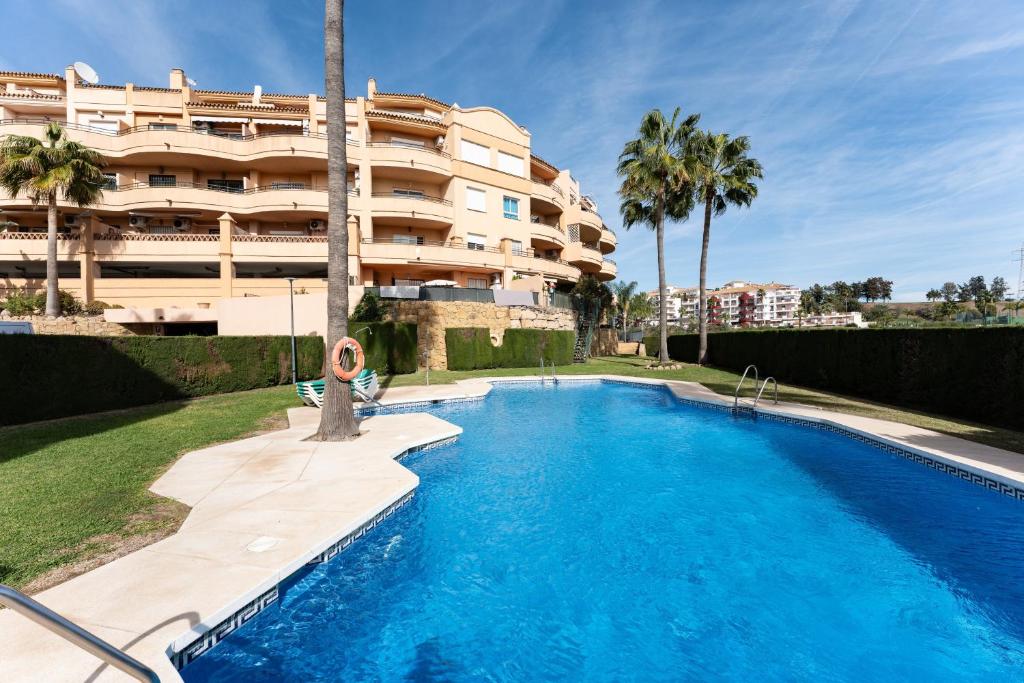 a swimming pool in front of a apartment building at Penthouse 3-bedroom duplex in Mijas