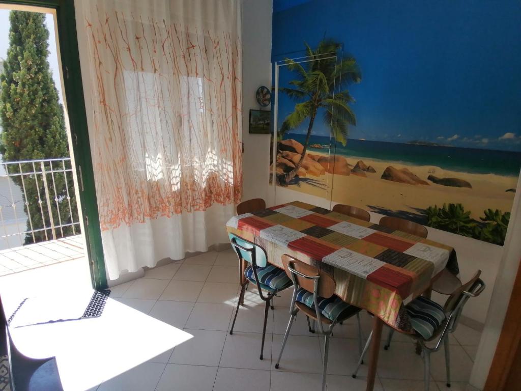 a dining room with a table and chairs and a window at Euroholiday Village 3G in Lido di Jesolo