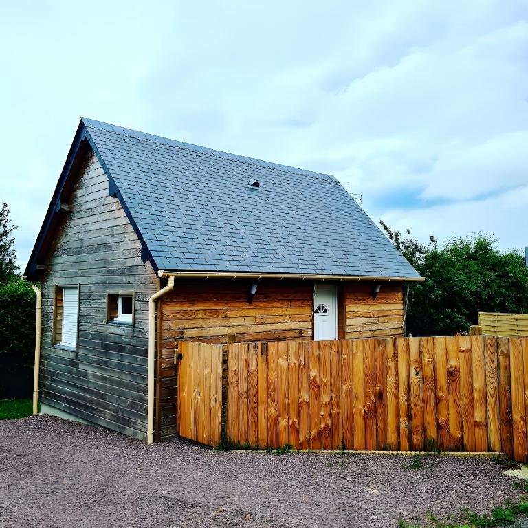a wooden shed with a fence in front of it at Chalet Honfleur in Honfleur