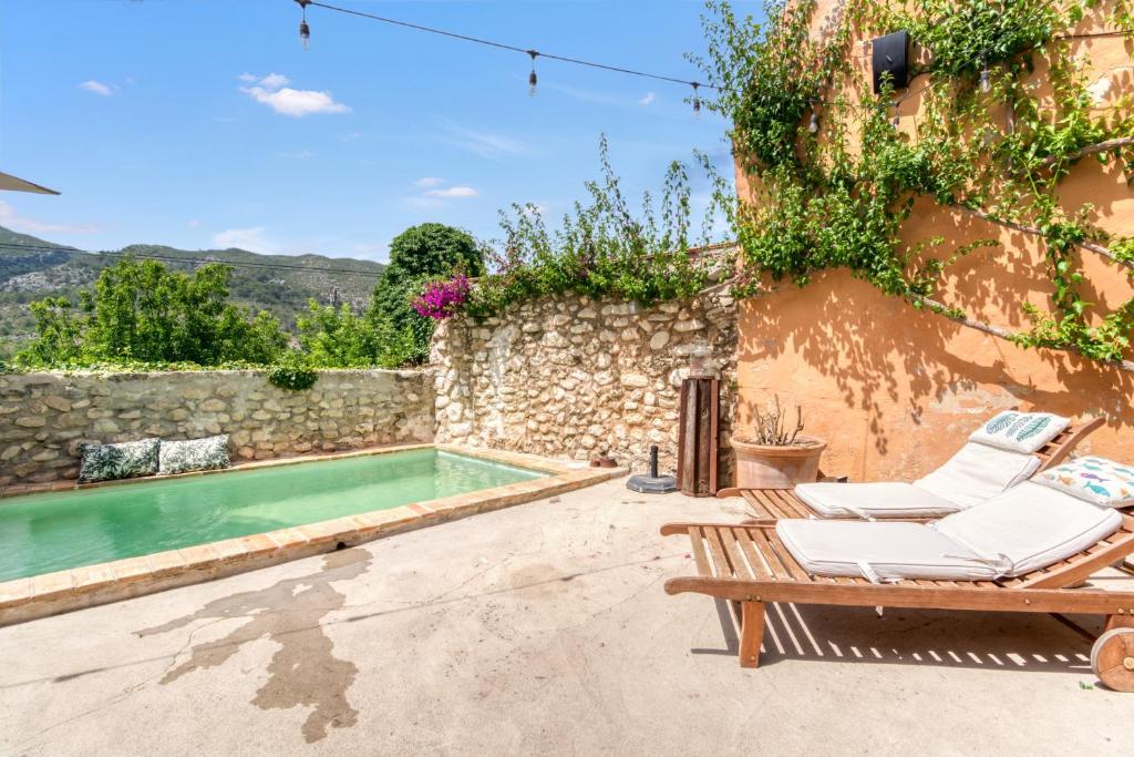 a patio with chairs and a swimming pool at Ca la Pasita 26 in Beniali