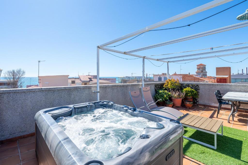 a hot tub on the roof of a house at Apartment with spa and bbq in El Vendrell