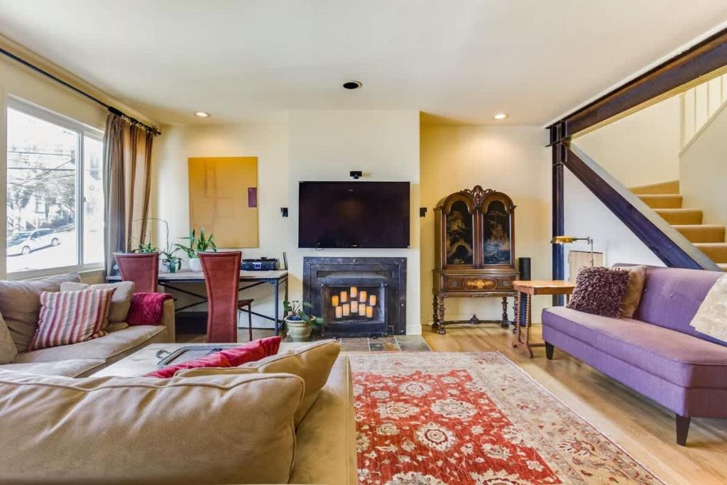 a living room with a couch and a fireplace at Two Bedroom, Two Newly Renovated Bathrooms, Deck in San Francisco