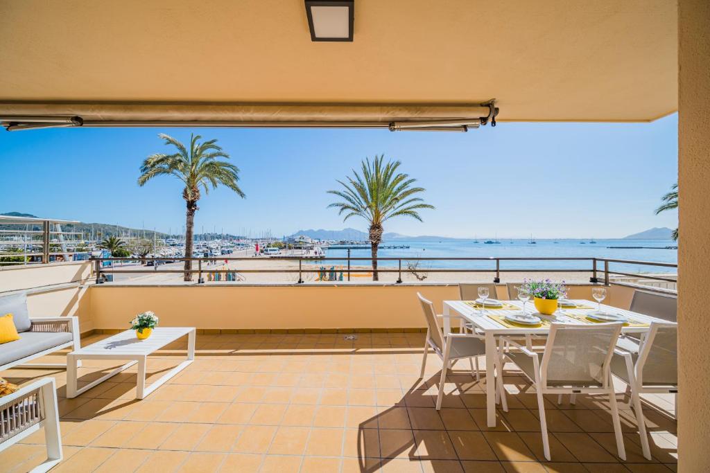 a balcony with a table and chairs and a view of the ocean at Cana Ferrera in Port de Pollensa