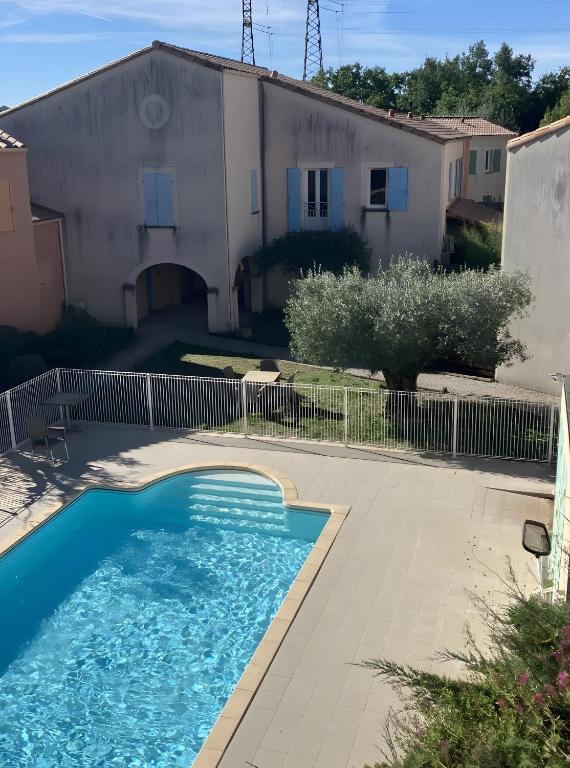 a swimming pool in front of a house at Maison en Drôme Provençale in Nyons