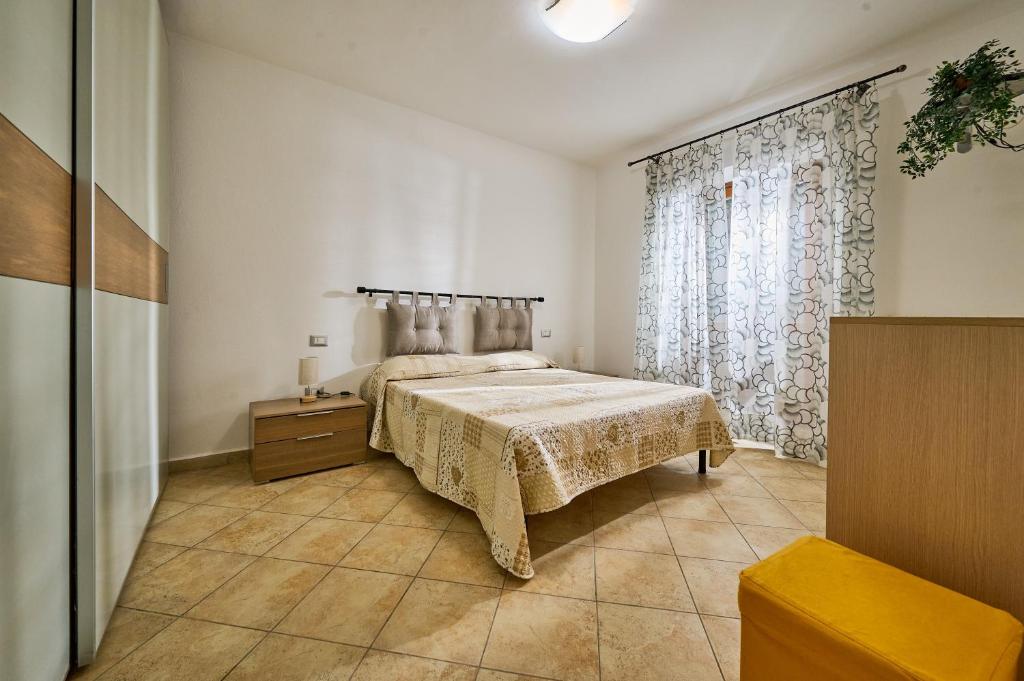a bedroom with a bed and a large window at Casa Martina in Sassetta