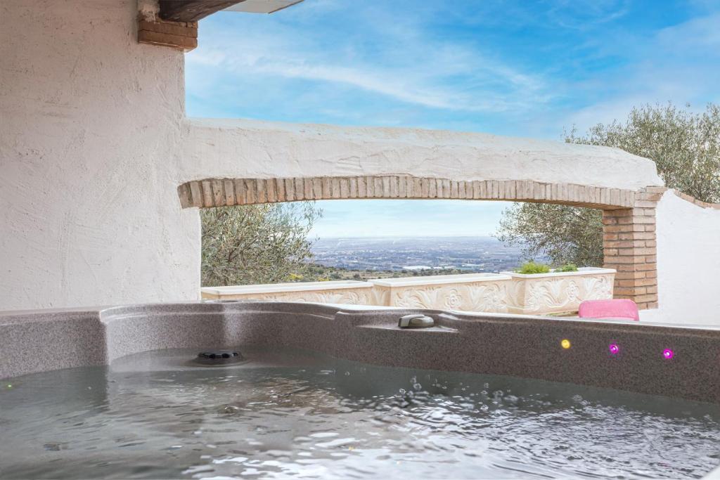 a jacuzzi tub with a view of the city at Tour Catalane in Ille-sur-Têt