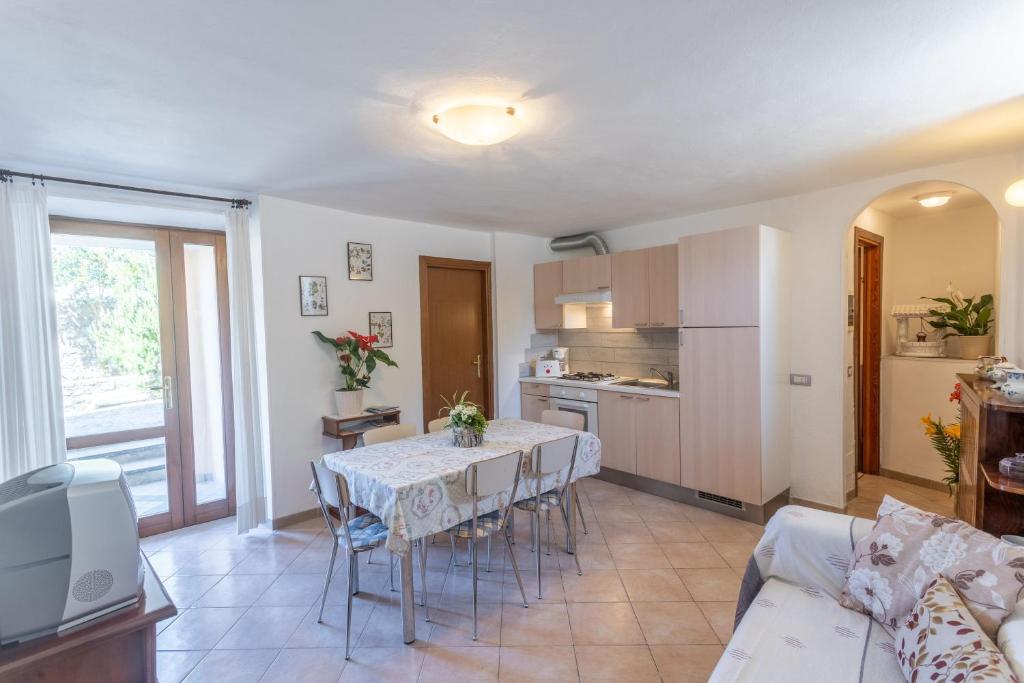 a kitchen and living room with a table and a couch at Casa Rita app 4 A in Tremosine Sul Garda