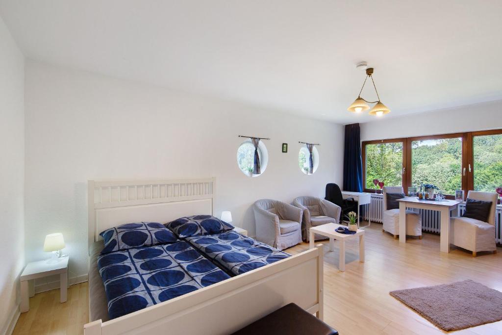 a bedroom with a bed and a living room at Ferienwohnung Waldblick in Remscheid