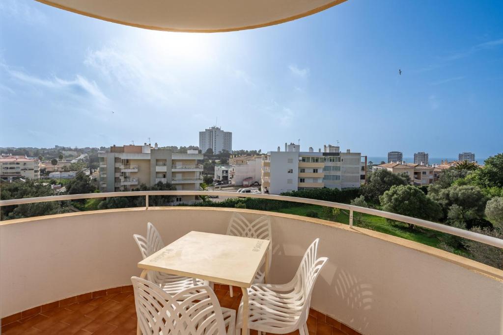 a balcony with a table and chairs and a view at Maralvor 301 in Alvor