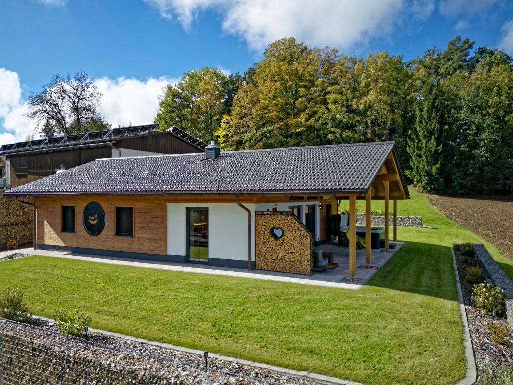 a home with a large yard and a building at Luxus-Chalet Mühlberg in Eppenschlag