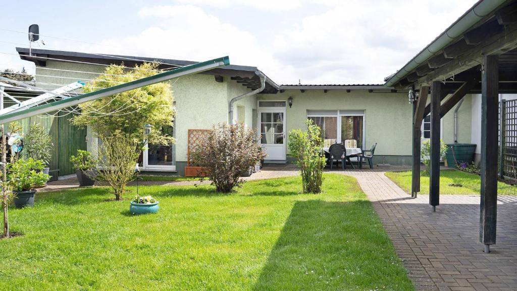 a house with a green yard with a patio at Ferienwohnung Strempel in Templin