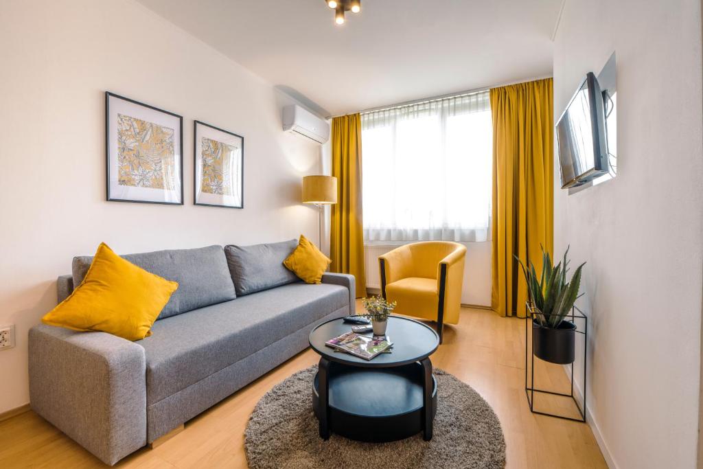 a living room with a couch and a table at PrimeStayBudapest in Budapest