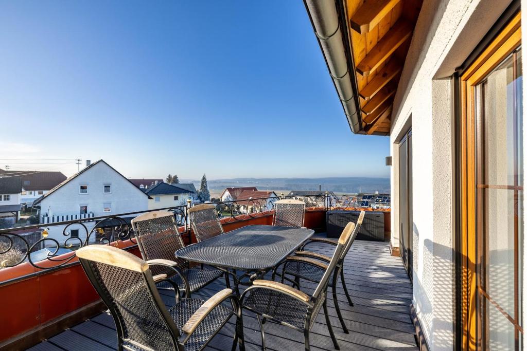 a table and chairs on a balcony with a view at Feriendomizil Berta Benzingen 2 in Winterlingen