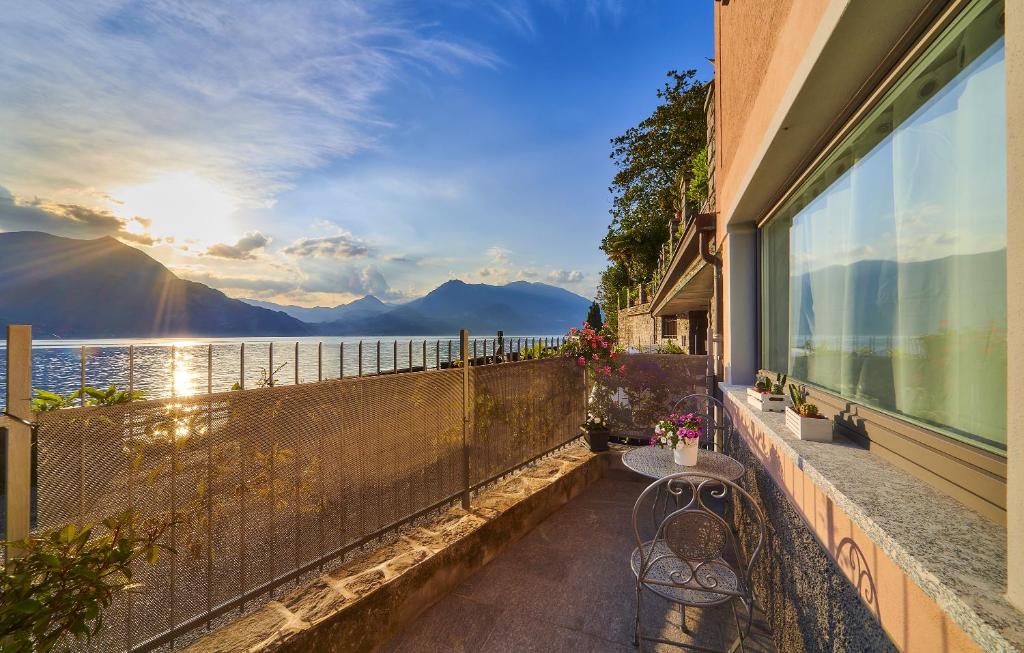 a balcony with a bench and a view of the water at El Lavandee in Varenna