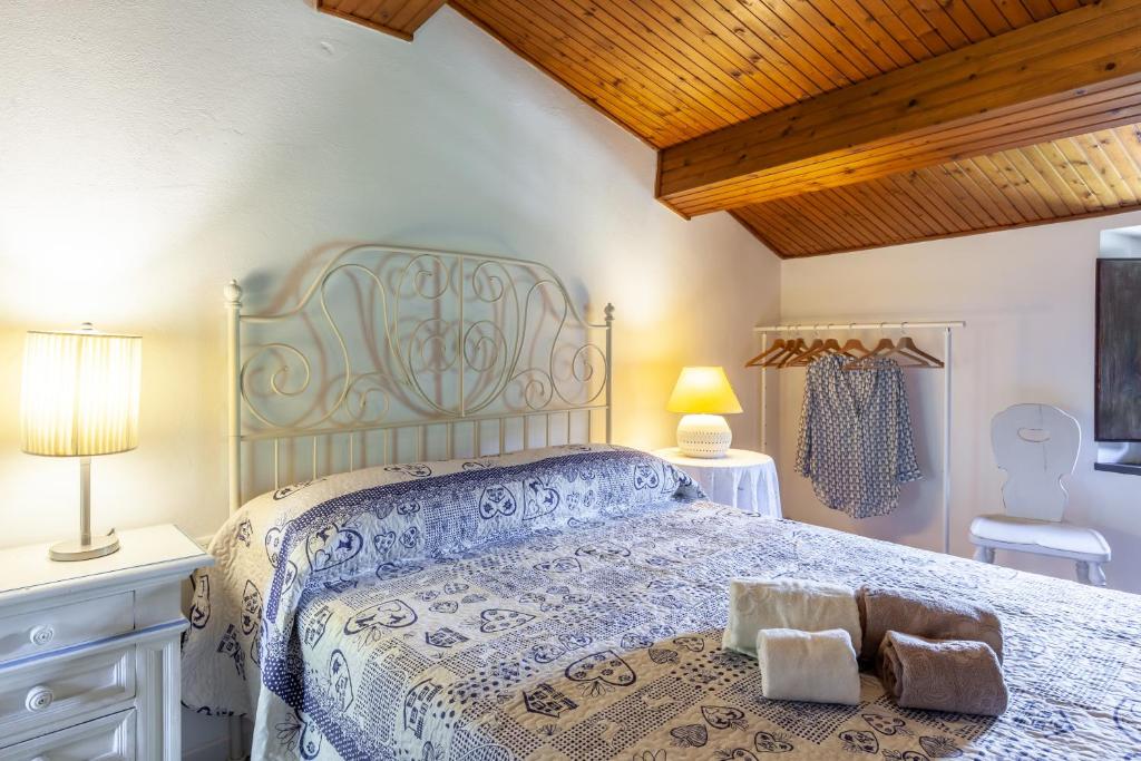 a bedroom with a bed with two towels on it at Domino Cottage - Monteggiori in Camaiore