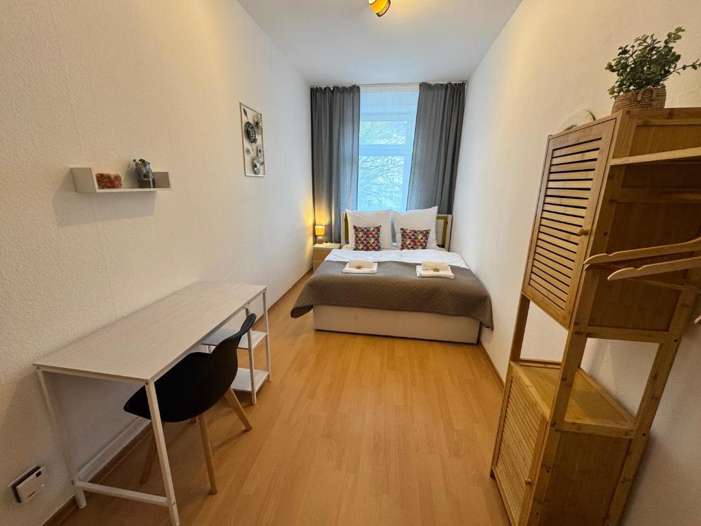 a small room with a bed and a window at Arminos Apartment Li in Chemnitz