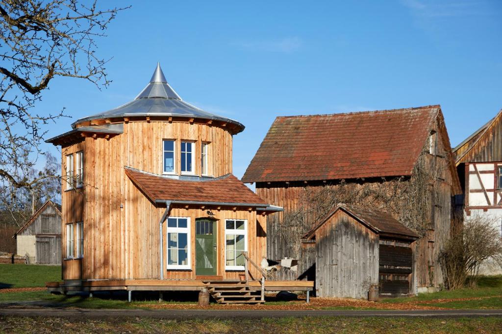 a large wooden house with a tin roof on top at Uptrulli-Minihaus in Vogt