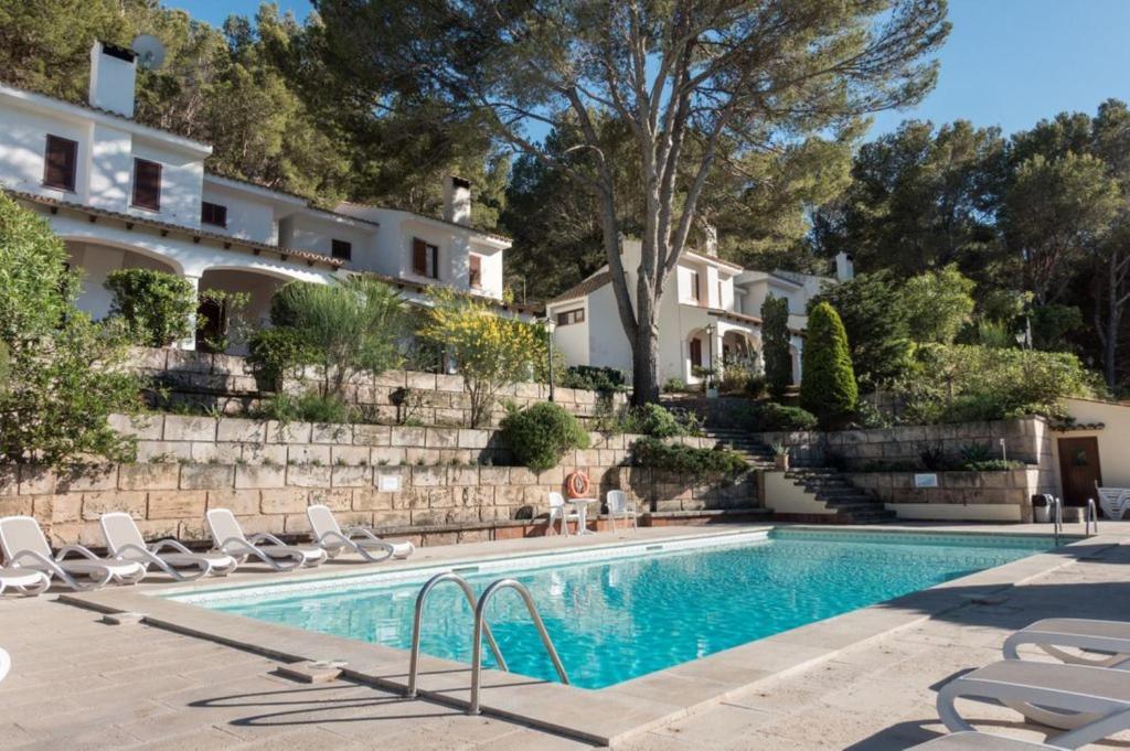 a swimming pool in front of a house at Can Botana 3 in Cala de Sant Vicenc