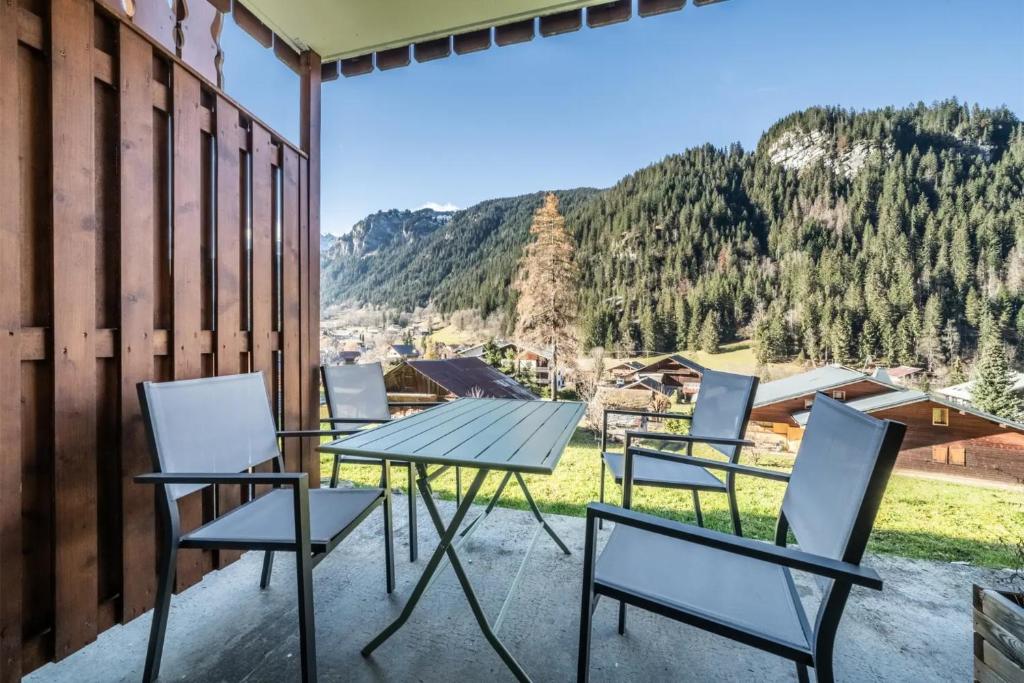 a table and chairs on a patio with a view at Duo d'appartements - Chatel in Châtel