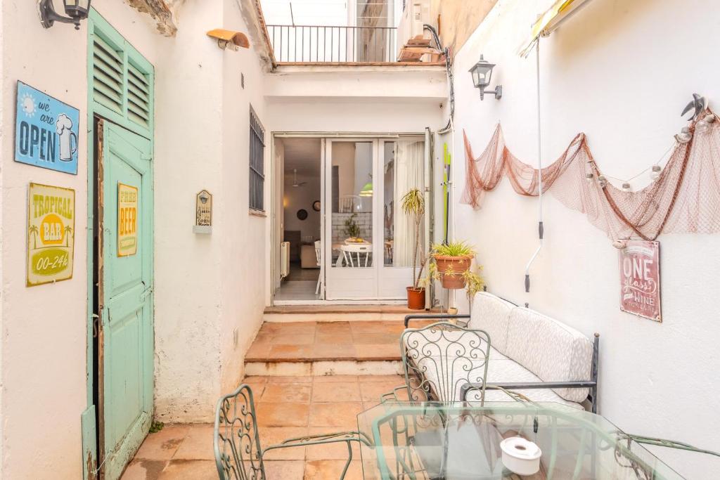 a patio with a glass table and chairs at Ca L' Anton in Palafrugell