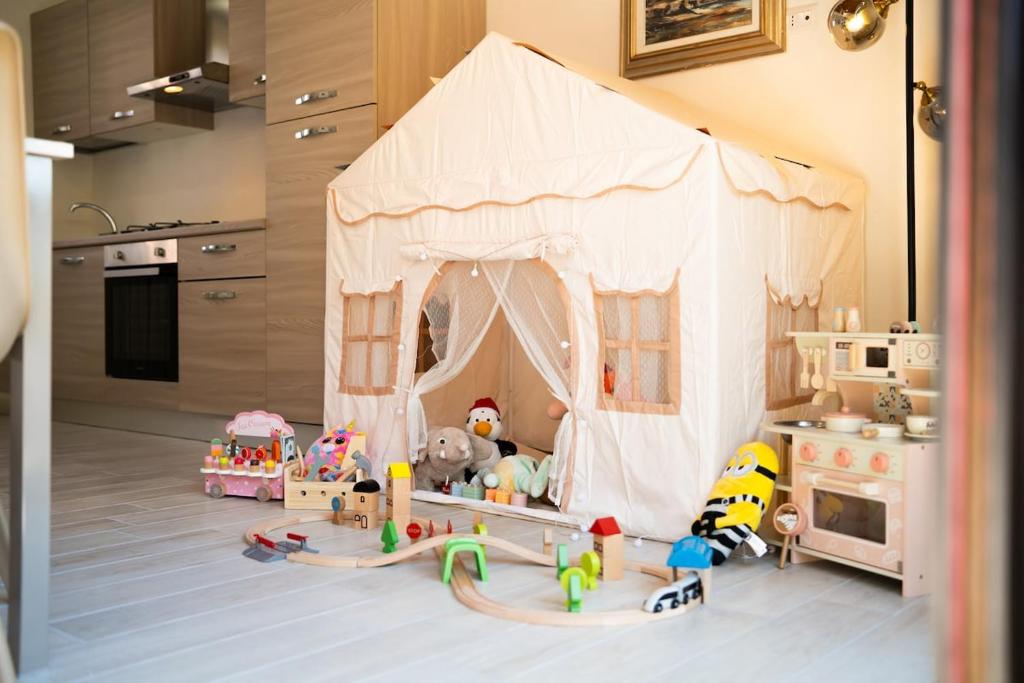 a room with a play tent with many toys in it at Begna Kiddie Paradise Poolside Retreat in Porlezza
