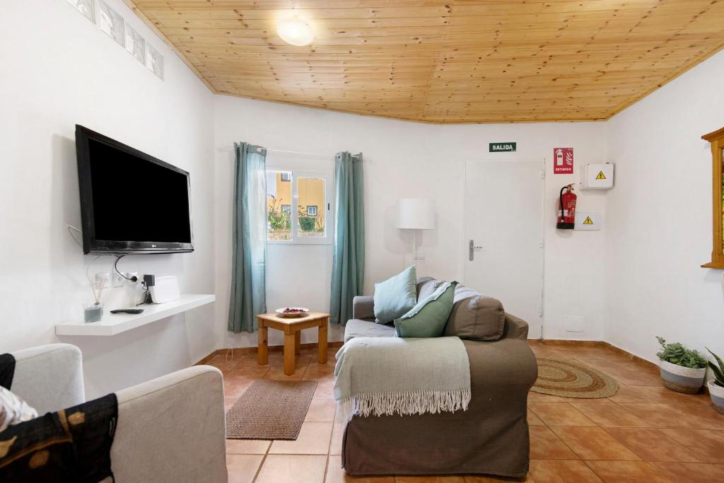 a living room with a couch and a flat screen tv at Casa Verol B in Moya