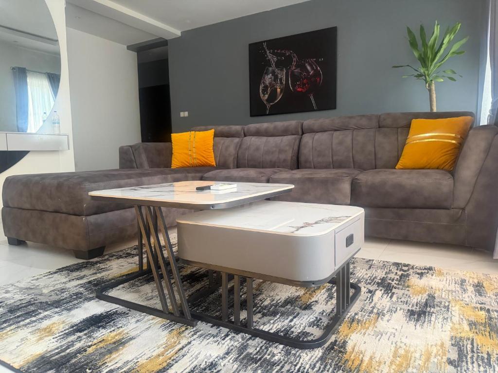 a living room with a couch and a table at Max Heights in Ikeja