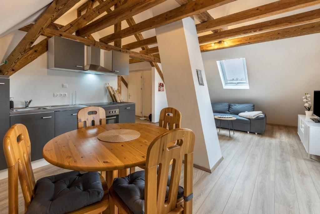 a kitchen and dining room with a wooden table and chairs at Ferienwohnung Degen in Donaueschingen