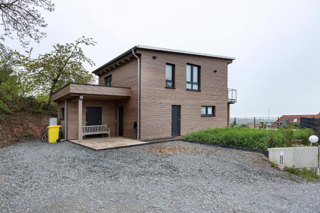 a small house with a bench in front of it at Ferienhaus mit Panoramablick in Gernrode