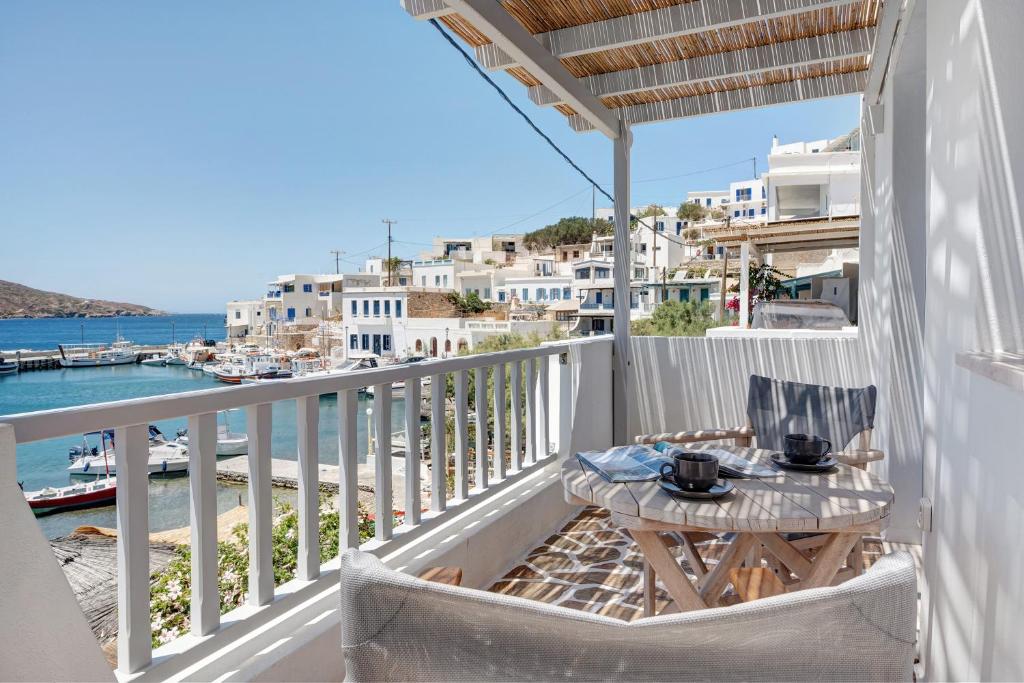 a balcony with a table and a view of the water at Nicolas House 4 in Rakhídhion