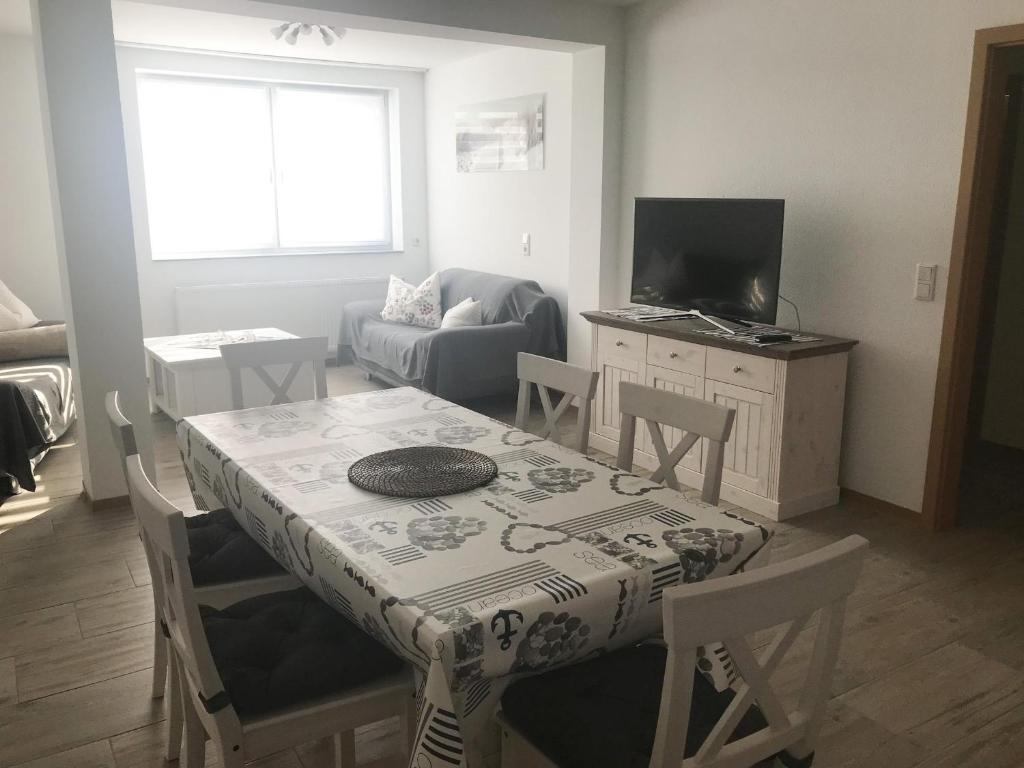 a living room with a table and a couch at Ferienwohnung, 110qm in Hohen Wangelin