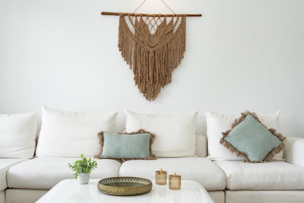 a living room with a white couch with pillows at Casa Ohana Fuengirola in Fuengirola