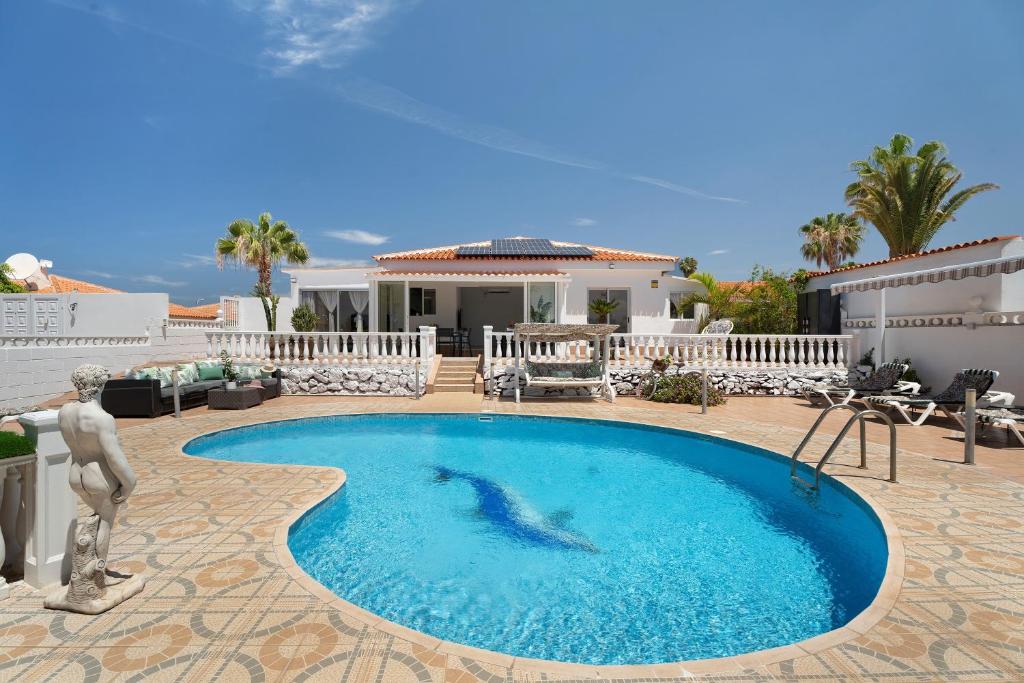 a swimming pool in front of a house at Villa Milena in Callao Salvaje
