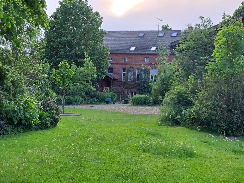 a house with a green lawn in front of it at Hof Schumacher in Gumtow