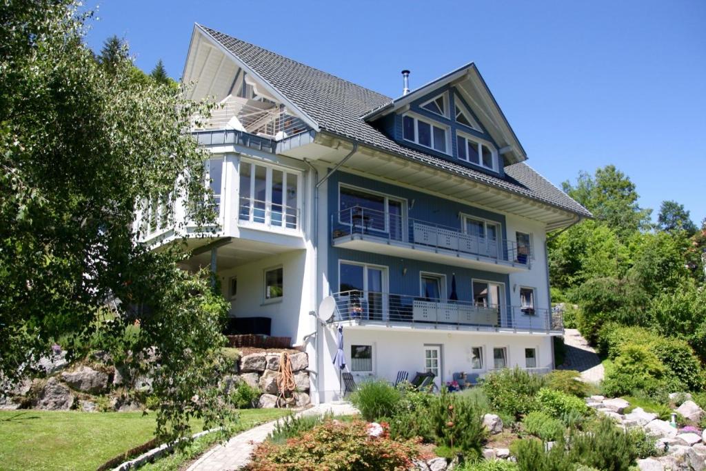 a large white house with blue trim at Haus Gisela - Stockkamp in Todtmoos
