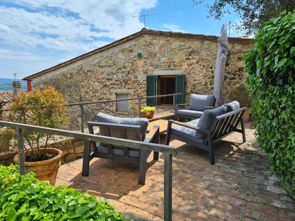 a patio with two chairs and a table at La Terrazza, Cetona, Toscana in Cetona