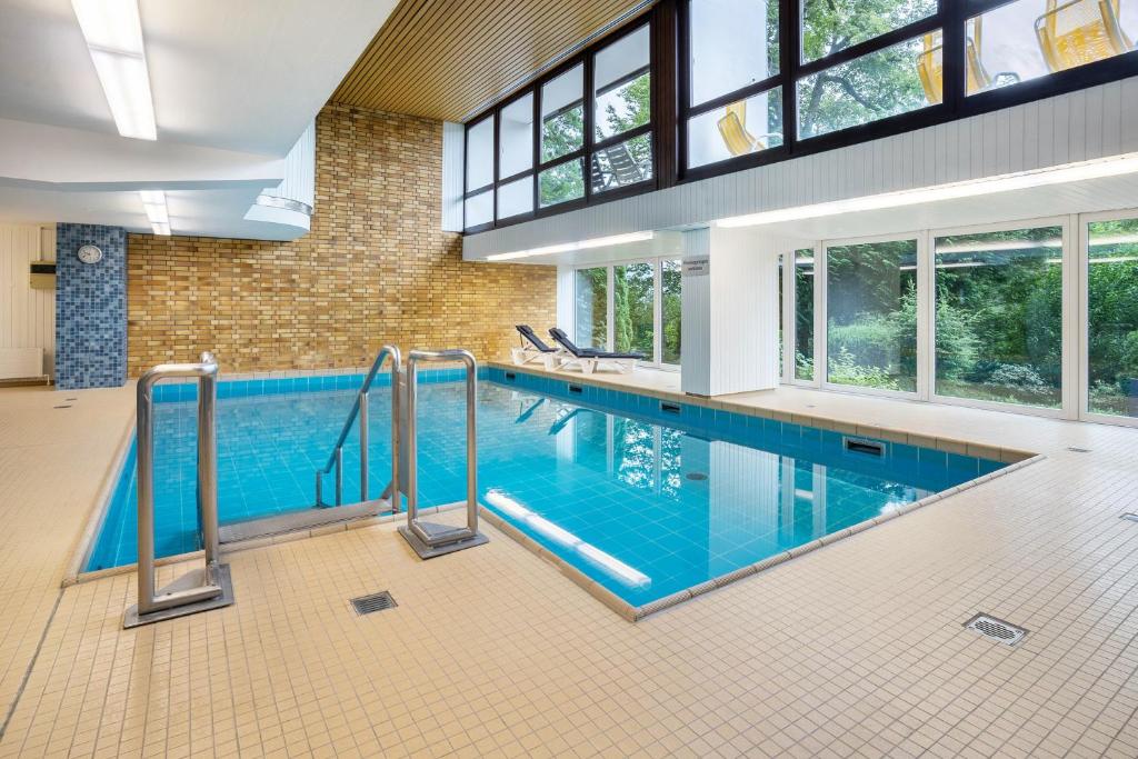 a large indoor swimming pool with blue water at Ferienwohnung Adrion in Bad Herrenalb