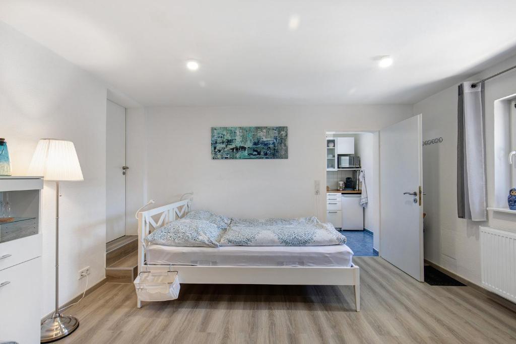 a bedroom with a white bed in a room at Ferienwohnung Norma in Taunusstein