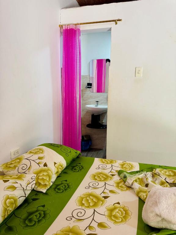 a bedroom with a bed with yellow flowers on it at Hostal Arambulo in Villavieja